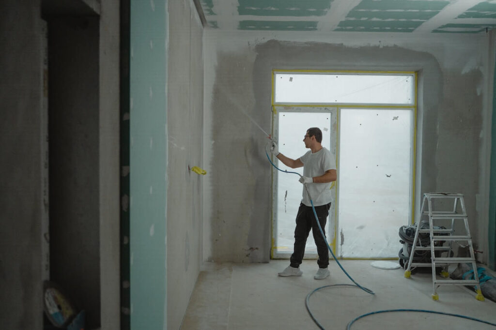 construction worker spraying the wall